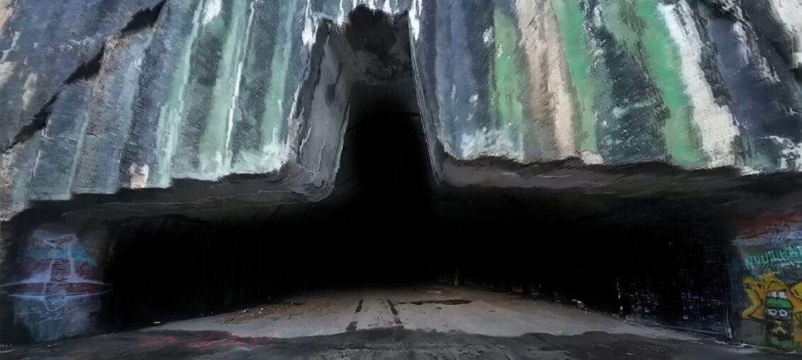 Abandoned military base with empty runways, decaying buildings, and rusting military equipment left behind.