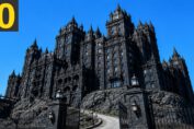 Haunted castle hotel illuminated at night with eerie fog and ghostly atmosphere.