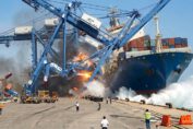 Large construction crane collapsing during a heavy lift operation after losing stability at a work site.